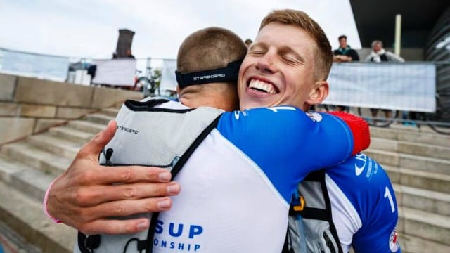 Daniel Hasulyo hugs his brother Bruno at the 2017 ISA World SUP and Paddleboard Championship in Denmark