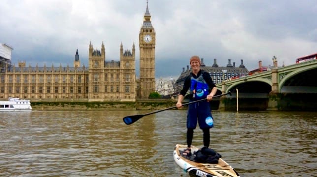 Paul Hyman of Active360 paddleboarding in front of Westminster and Big Ben