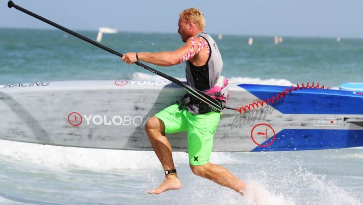 Garrett Fletcher dashes to the shore during a SUP race while under contract with Yoloboard