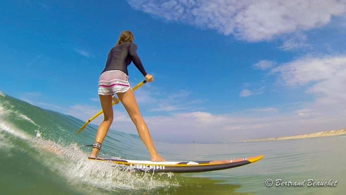 French SUP Surf Champion Delphine Macaire riding the swell in Aquitaine, France