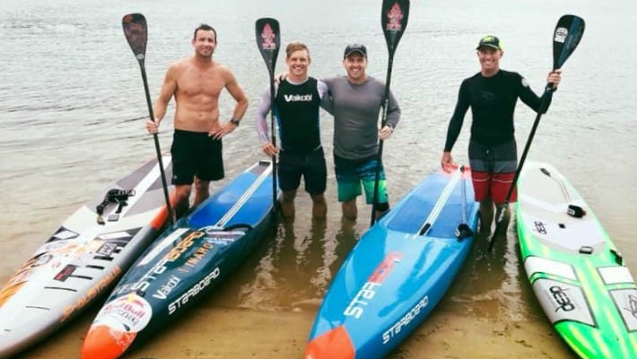 Michae Booth is in good company training for a competitive event with Starboard SUP teammates