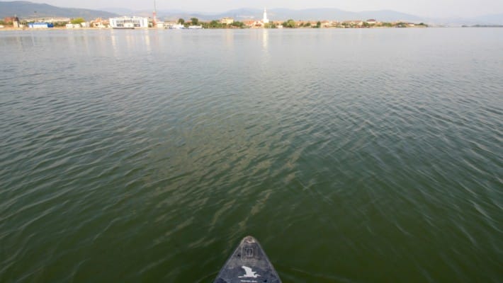 Mark Hines faces a small waterside town in Serbia during his SUP expedition across Europe's largest waterway after the Volga
