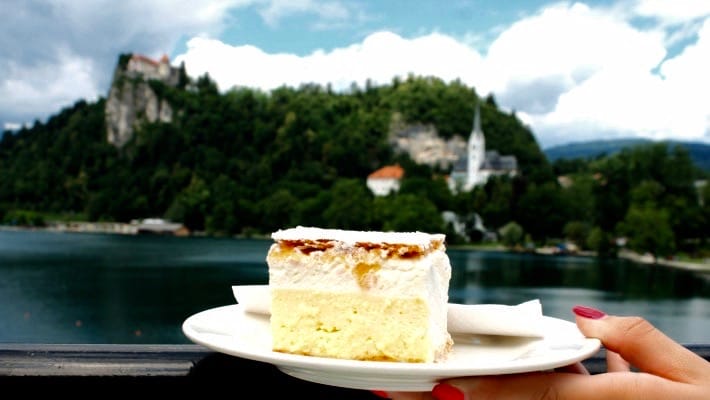 You can enjoy a slice of kremšnita, one of Slovenia famed sweet delicacies, while admiring the views over Lake Bled