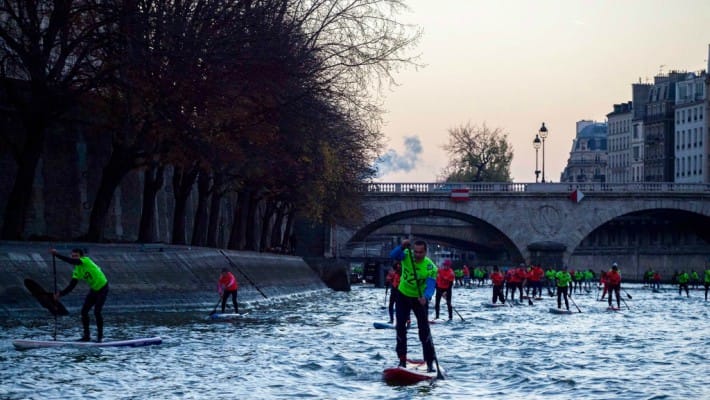 Paddlers pick up the pace along the Seine at the 2016 Nautic SUP Paris Crossing