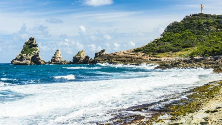 The waves come rushing in on a sandy beach in Guadeloupe, French Caribbean
