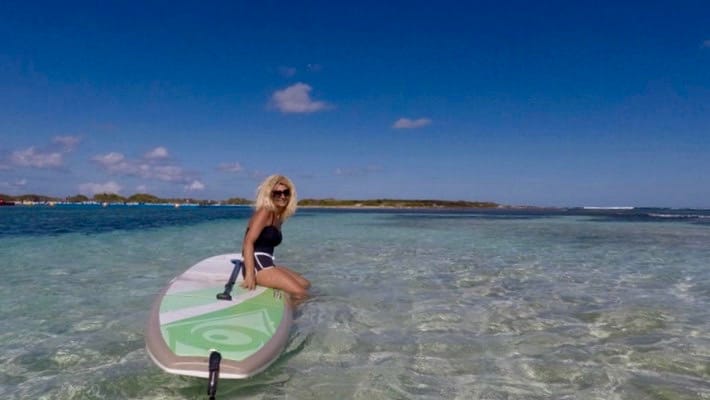 Philippe Momparler's wife and business partner aboard her stand up paddleboard in Saint-Martin